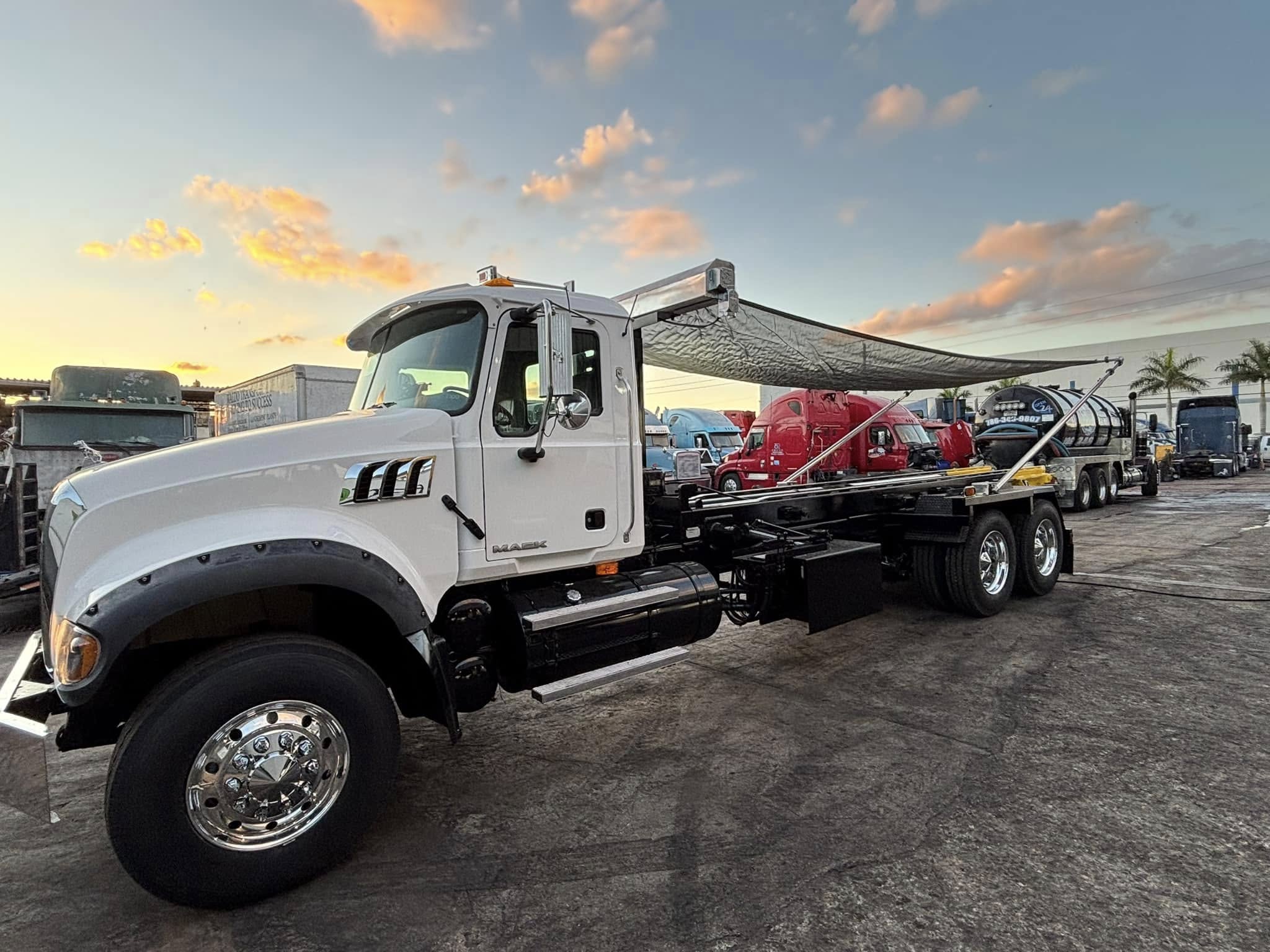 Heavy-duty roll-off dumpster truck ready for commercial dumpster rentals in Saginaw MI