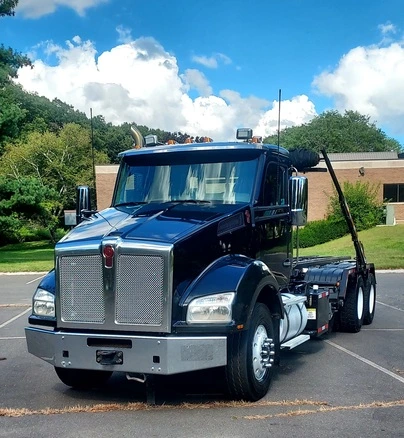 Gallery 6 Black heavy-duty roll-off dumpster truck ready for construction and cleanup projects in Saginaw Michigan