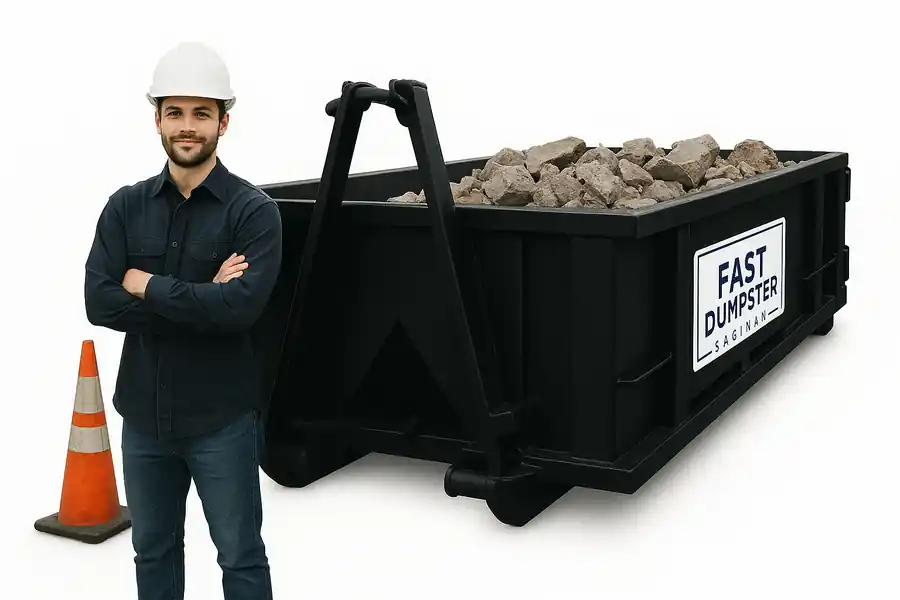Construction worker standing next to a Fast Dumpster Saginaw roll off dumpster filled with concrete debris